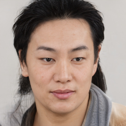 Joyful asian young-adult male with medium  brown hair and brown eyes