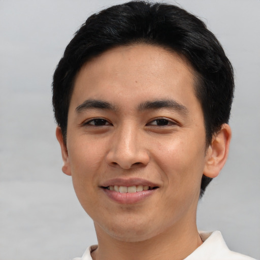 Joyful asian young-adult male with short  brown hair and brown eyes
