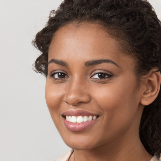 Joyful latino young-adult female with long  brown hair and brown eyes