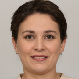 Joyful white adult female with short  brown hair and brown eyes