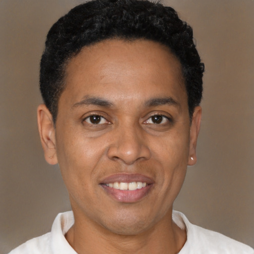 Joyful latino young-adult male with short  brown hair and brown eyes