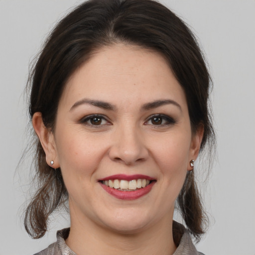 Joyful white young-adult female with medium  brown hair and brown eyes