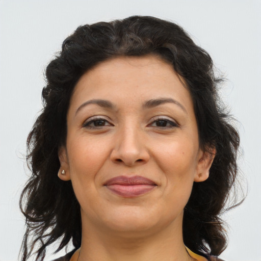 Joyful latino adult female with medium  brown hair and brown eyes