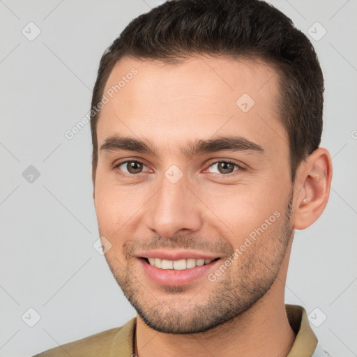 Joyful white young-adult male with short  brown hair and brown eyes