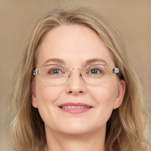 Joyful white adult female with long  brown hair and blue eyes