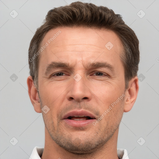 Joyful white adult male with short  brown hair and brown eyes