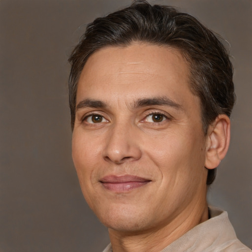 Joyful white adult male with short  brown hair and brown eyes