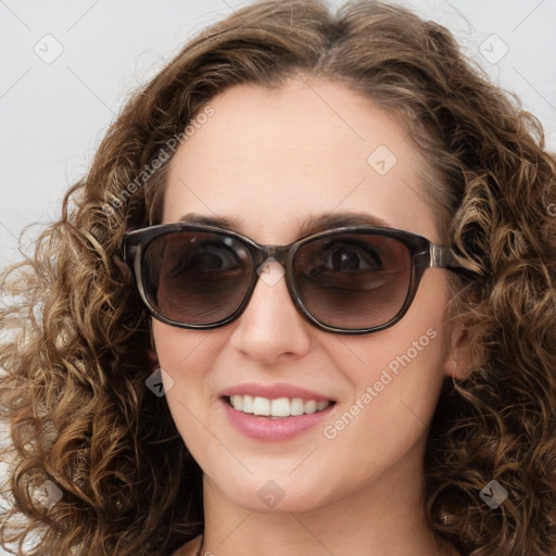 Joyful white young-adult female with long  brown hair and blue eyes