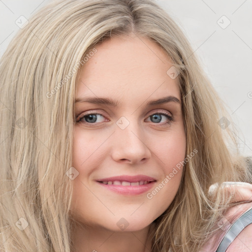 Joyful white young-adult female with long  brown hair and blue eyes