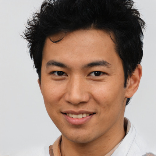 Joyful asian young-adult male with short  brown hair and brown eyes