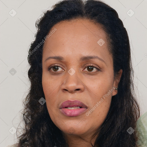 Joyful latino adult female with long  brown hair and brown eyes