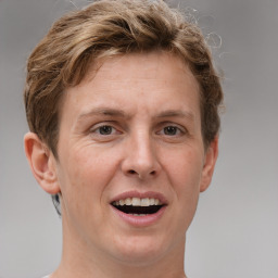 Joyful white adult female with short  brown hair and grey eyes