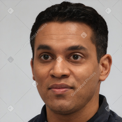 Joyful black young-adult male with short  black hair and brown eyes