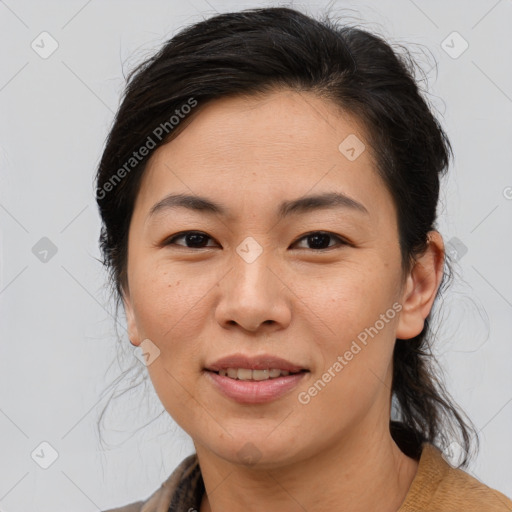 Joyful asian adult female with medium  brown hair and brown eyes