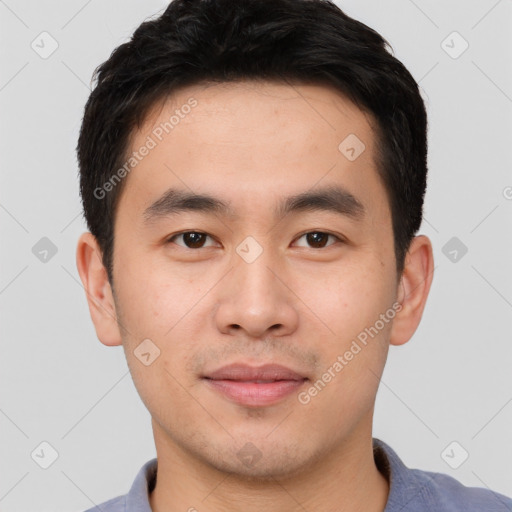 Joyful asian young-adult male with short  black hair and brown eyes