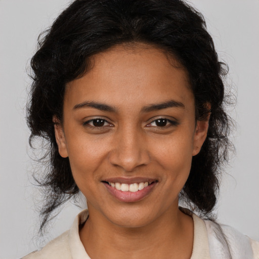 Joyful latino young-adult female with medium  brown hair and brown eyes