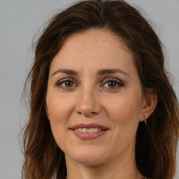 Joyful white adult female with long  brown hair and brown eyes