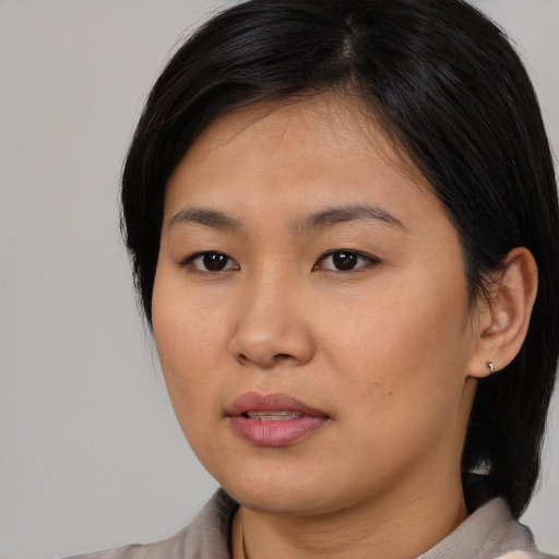 Neutral asian young-adult female with medium  brown hair and brown eyes
