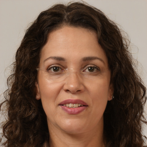 Joyful white adult female with long  brown hair and brown eyes