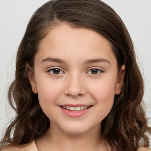 Joyful white child female with long  brown hair and brown eyes