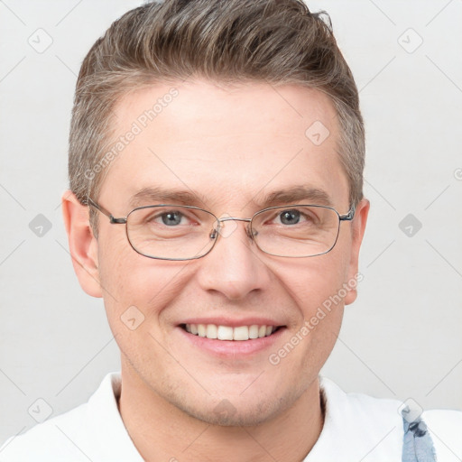 Joyful white adult male with short  brown hair and grey eyes