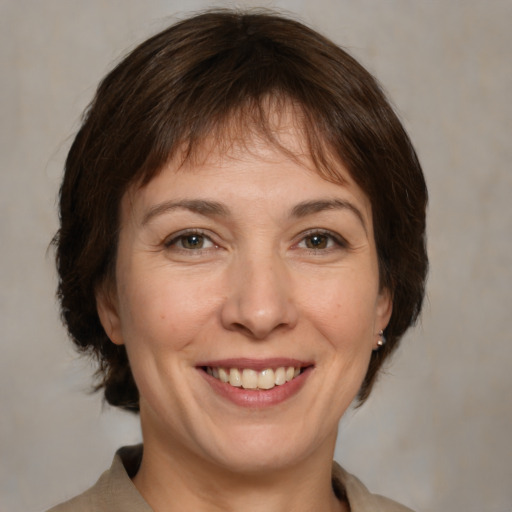 Joyful white adult female with medium  brown hair and brown eyes