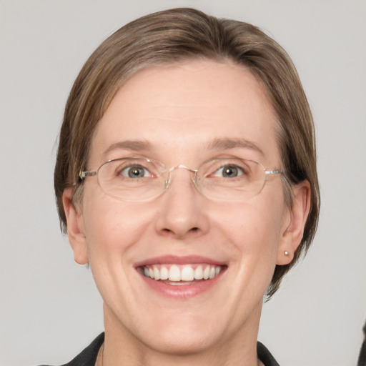 Joyful white adult female with medium  brown hair and grey eyes