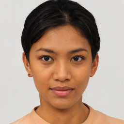 Joyful latino young-adult female with short  black hair and brown eyes