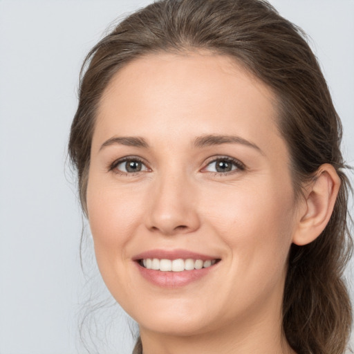 Joyful white young-adult female with medium  brown hair and brown eyes