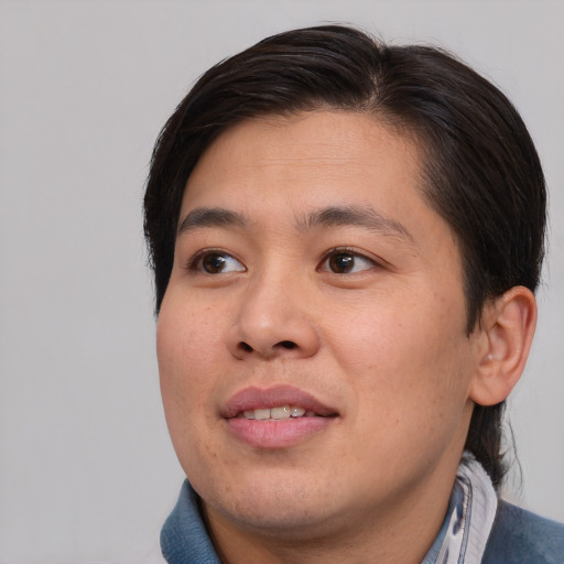 Joyful asian young-adult male with medium  brown hair and brown eyes