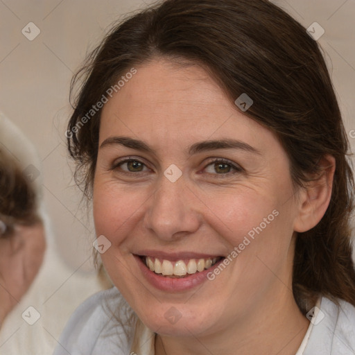 Joyful white adult female with medium  brown hair and brown eyes