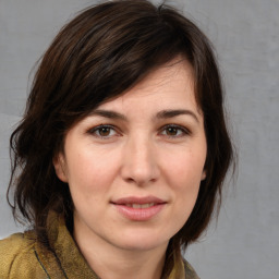 Joyful white adult female with medium  brown hair and brown eyes