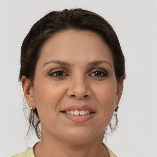 Joyful white young-adult female with medium  brown hair and grey eyes