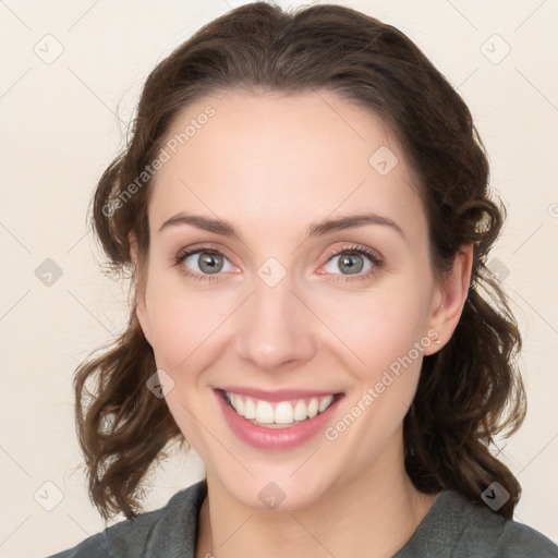 Joyful white young-adult female with medium  brown hair and blue eyes