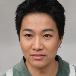 Joyful asian young-adult female with short  black hair and brown eyes