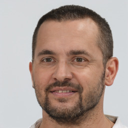 Joyful white adult male with short  brown hair and brown eyes