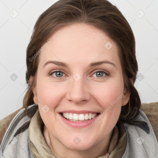 Joyful white young-adult female with medium  brown hair and grey eyes