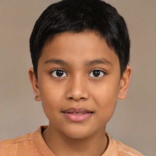 Joyful latino child male with short  brown hair and brown eyes