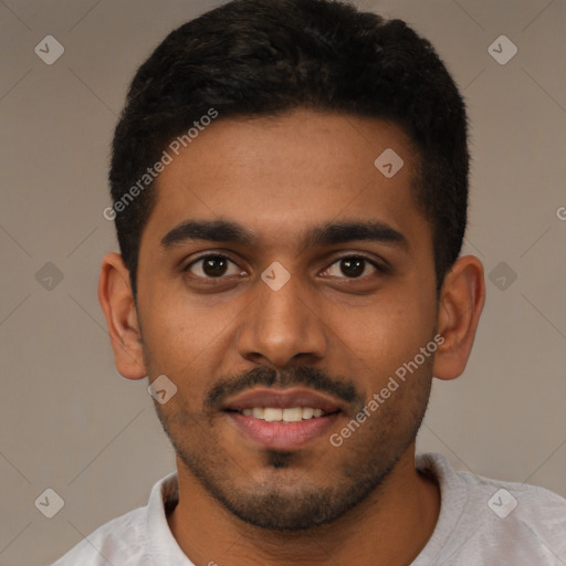 Joyful black young-adult male with short  black hair and brown eyes