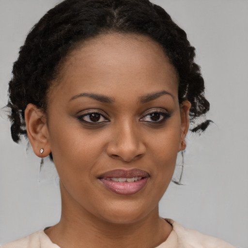 Joyful black young-adult female with medium  brown hair and brown eyes