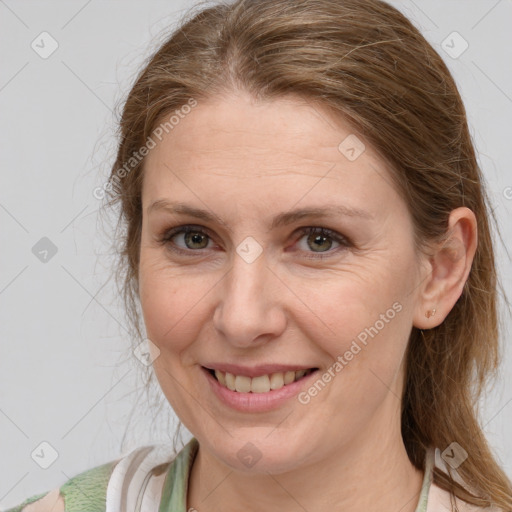 Joyful white adult female with medium  brown hair and blue eyes