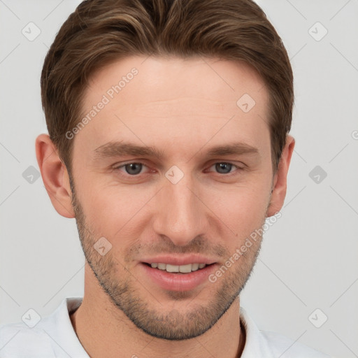 Joyful white young-adult male with short  brown hair and grey eyes