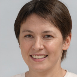 Joyful white adult female with short  brown hair and brown eyes