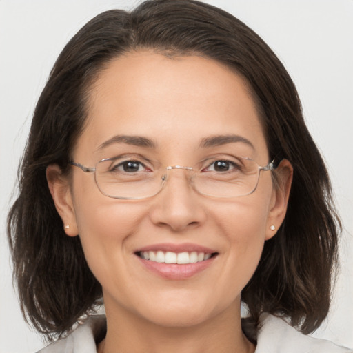 Joyful white adult female with medium  brown hair and brown eyes