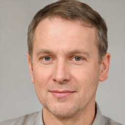 Joyful white adult male with short  brown hair and brown eyes