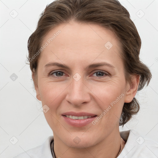 Joyful white adult female with medium  brown hair and grey eyes