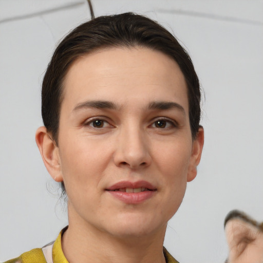 Joyful white young-adult female with short  brown hair and brown eyes