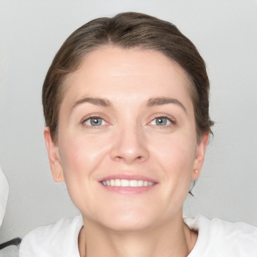 Joyful white young-adult female with medium  brown hair and grey eyes