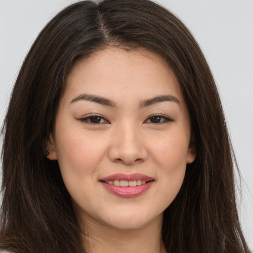 Joyful white young-adult female with long  brown hair and brown eyes