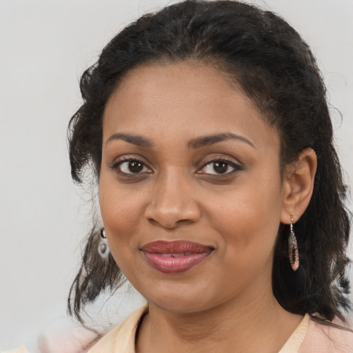 Joyful black young-adult female with medium  brown hair and brown eyes